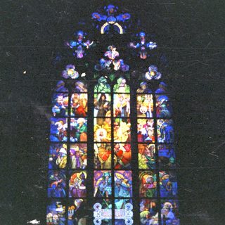 Detailed stained glass window depicting biblical scenes and figures.