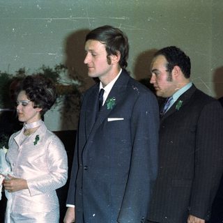 Wedding portrait of a couple and their attendants.