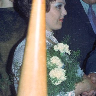 Couple with guests at a formal event, likely a wedding.