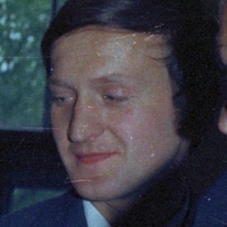 Couple with guests at a formal event, likely a wedding.
