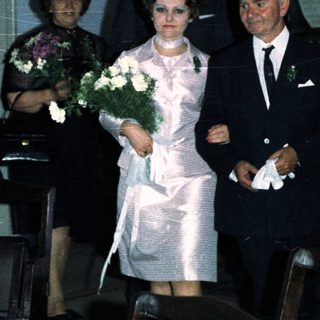 Couple walking down an aisle during a wedding ceremony.