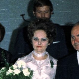 Couple walking down an aisle during a wedding ceremony.
