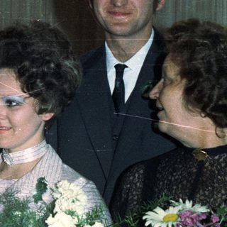 Family portrait with a baby, likely a wedding or celebration.