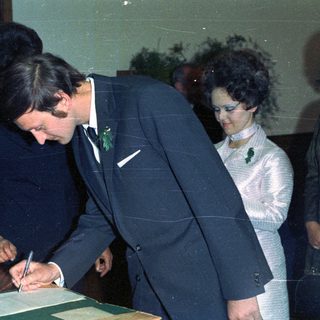Prince Charles signing a document, likely a marriage certificate.
