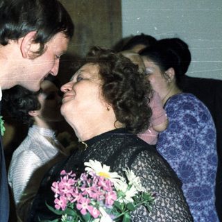 Couple embracing, likely at a wedding or celebratory event.