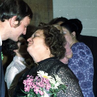 Couple embracing, likely at a wedding or celebratory event.