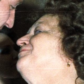 Couple embracing, likely at a wedding or celebratory event.