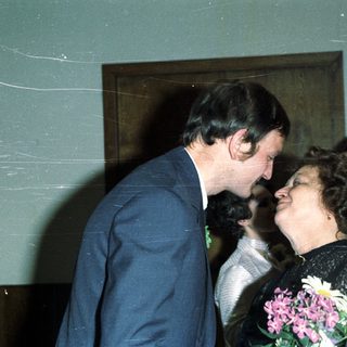 Couple embracing, likely at a wedding or celebratory event.