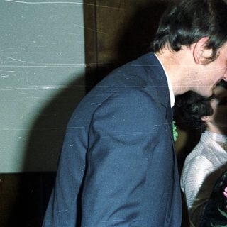 Couple embracing, likely at a wedding or celebratory event.