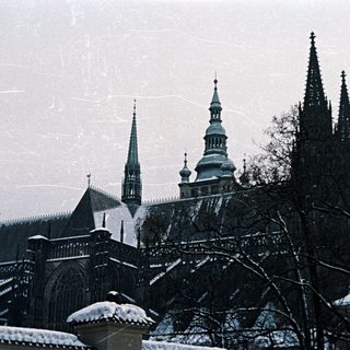 Snow-covered gothic cathedral with prominent spires and dome.
