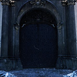 Elaborate, snow-covered doorway of a historic building.