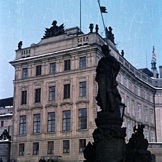 Statue and building covered in snow in a winter scene.