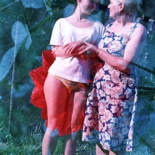 Girl in a tutu talks with a woman outdoors.