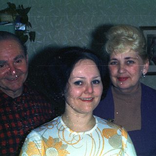 Three people posing for a photograph indoors.