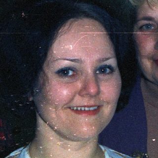 Three people posing for a photograph indoors.