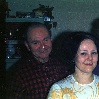 Three people posing for a photograph indoors.