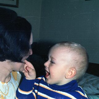 Woman and baby appear to be interacting closely.