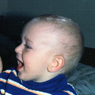 Woman and baby appear to be interacting closely.