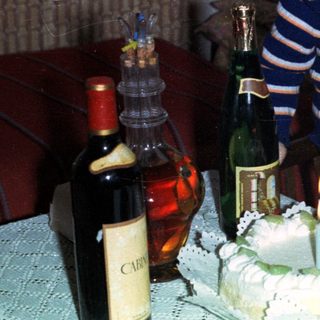 Boy with cake and champagne, likely celebrating a birthday.