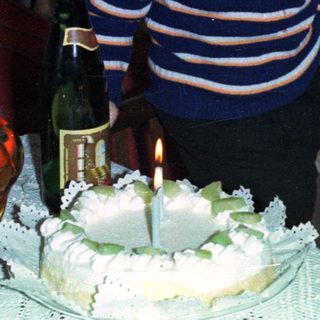 Boy with cake and champagne, likely celebrating a birthday.