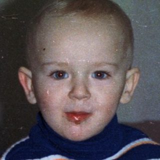 Boy with cake and champagne, likely celebrating a birthday.