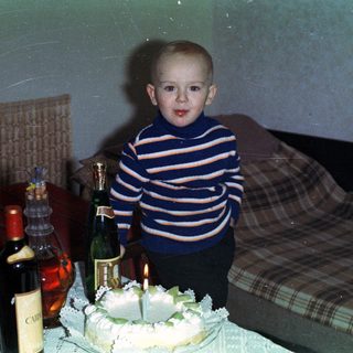 Boy with cake and champagne, likely celebrating a birthday.