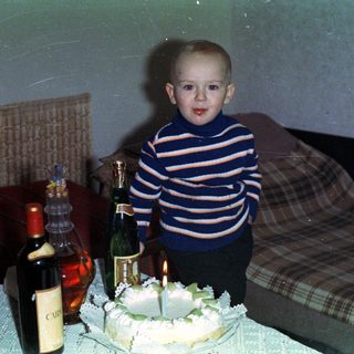 Boy with cake and champagne, likely celebrating a birthday.