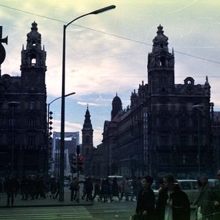 Street scene with tall buildings and pedestrian traffic.