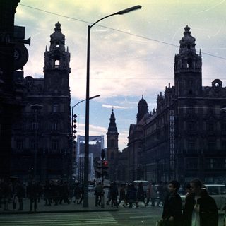 Street scene with tall buildings and pedestrian traffic.