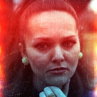 Here's a brief summary of the image: Portrait of a woman with a distressed, colorful photographic effect.