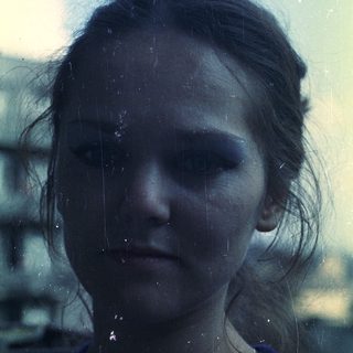 Close-up portrait of a person with visible film grain.
