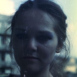 Close-up portrait of a person with visible film grain.