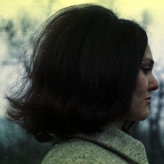 Side profile of a woman with short, dark hair.