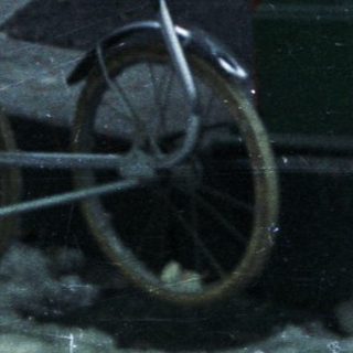 Man pushes a pram across a snowy landscape.