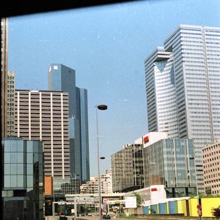 High-rise buildings and a road with traffic.