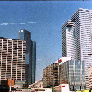 Here's a brief summary of the image: Skyscrapers and modern buildings dominate a cityscape scene.