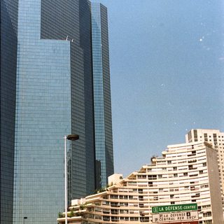Here's a brief summary of the image: Skyscrapers and apartment buildings in a Parisian business district.