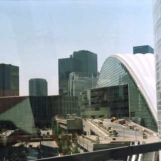 Convention center exterior with city skyscrapers in the background.