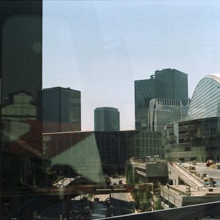 Convention center exterior with city skyscrapers in the background.
