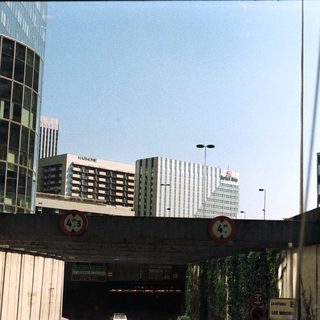 High-rise buildings seen through a highway overpass.