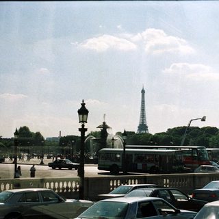 Paris cityscape with Eiffel Tower, obelisk, and traffic.