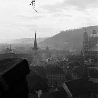 Overlooking a historic European city with a hazy, overcast sky.