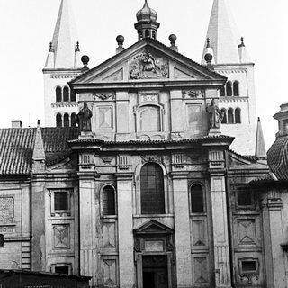 Black and white photo of a church facade with people.