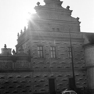 Black and white photo of an ornate building and cars.