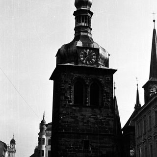 Black and white photo of a clock tower and buildings.