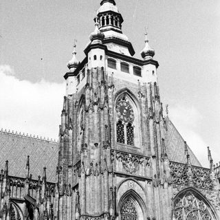 Black and white image of a tall, ornate cathedral tower.