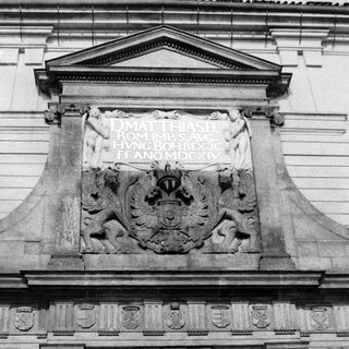 Black and white image of a sculpted coat of arms.
