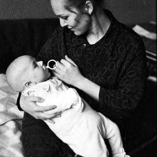 Woman gently cradling and comforting a baby.