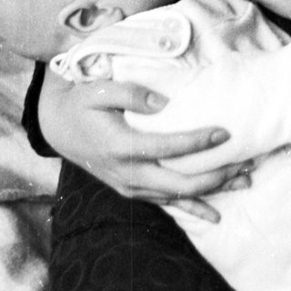 Woman gently cradling and comforting a baby.