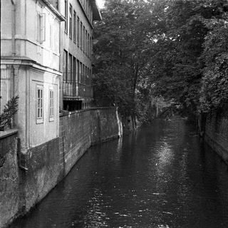 A canal runs between buildings with visible windows.